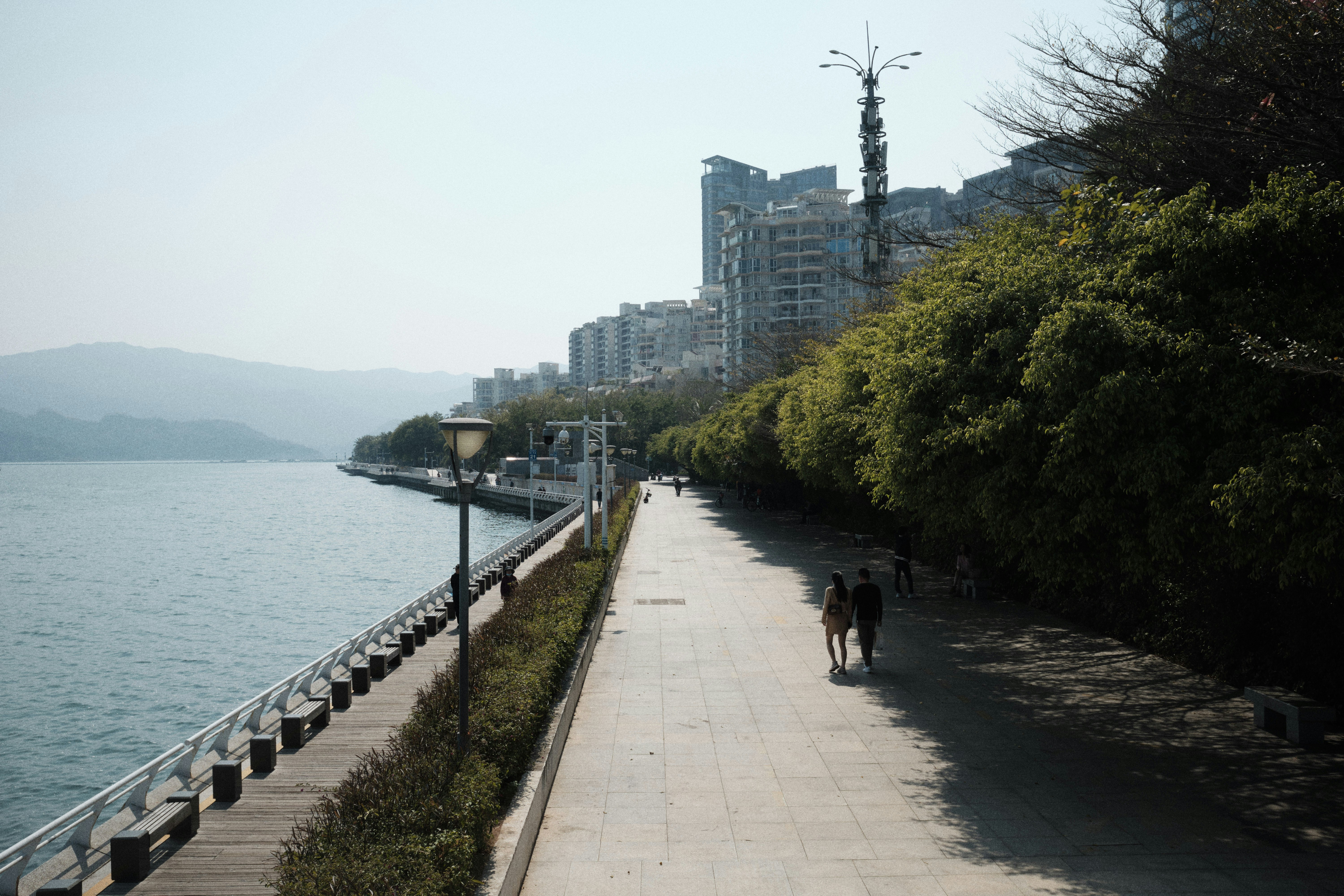 pedestrian walking path along a beautiful urban riverfront during sunset