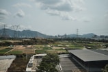 an aerial view of a parking lot with mountains in the background