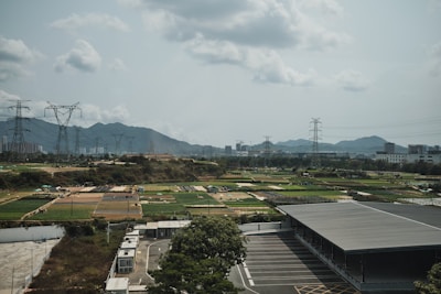 an aerial view of a parking lot with mountains in the background