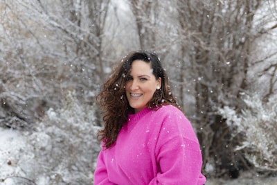 A stylish woman wearing a colorful, warm sweater outdoors in winter.