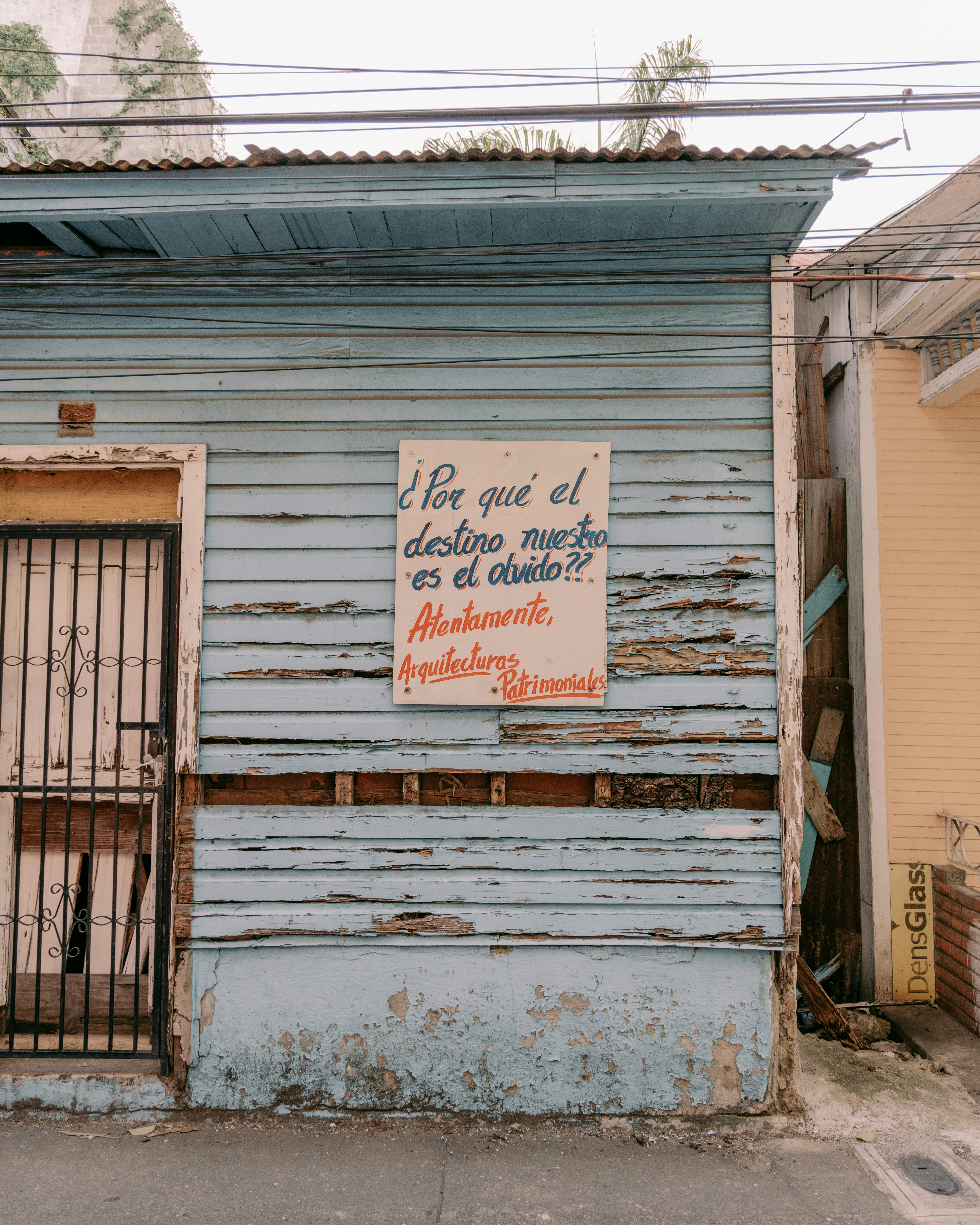 a blue building with a sign on the side of it