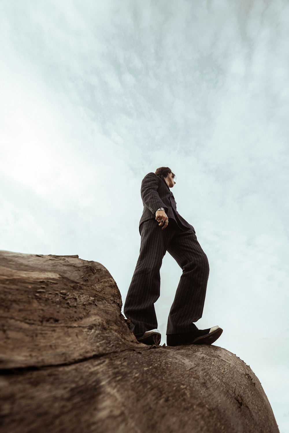 a man standing on top of a large rock