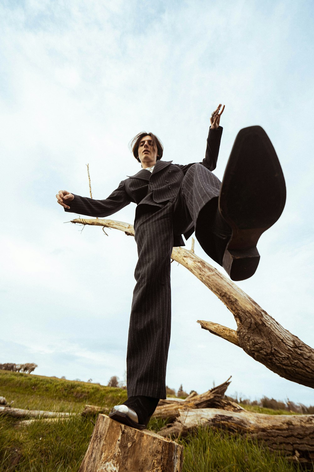 a man standing on top of a tree stump