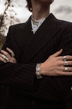 a man in a pinstripe suit with his arms crossed