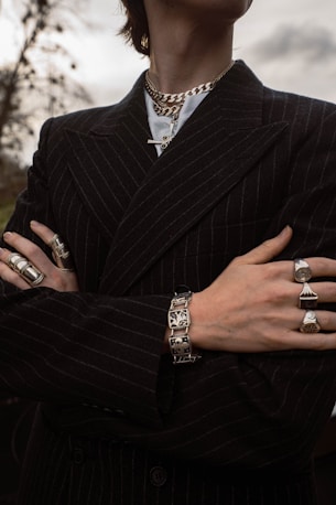 a man in a pinstripe suit with his arms crossed