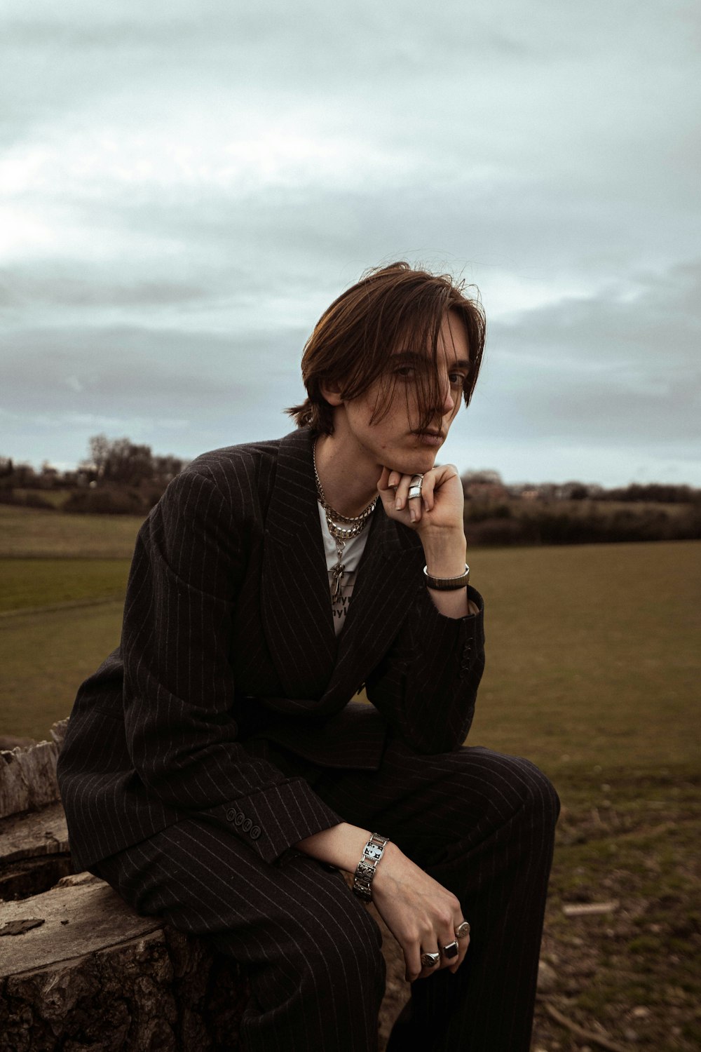 a man in a suit smoking a cigarette