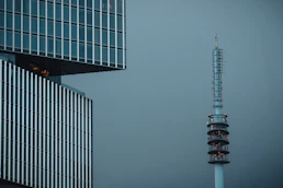 a very tall building next to a very tall tower