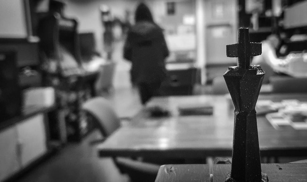 a black and white photo of people in a kitchen