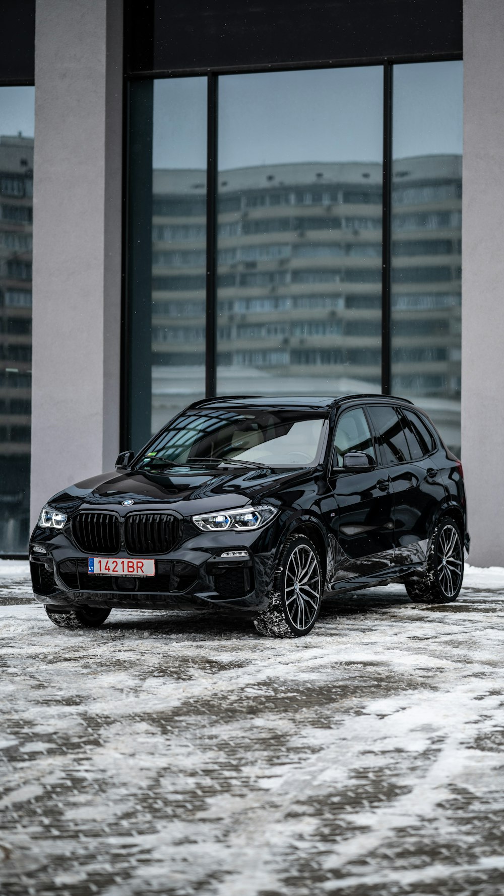 a black car parked in front of a building