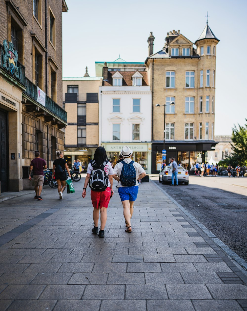 a couple of people walking down a street