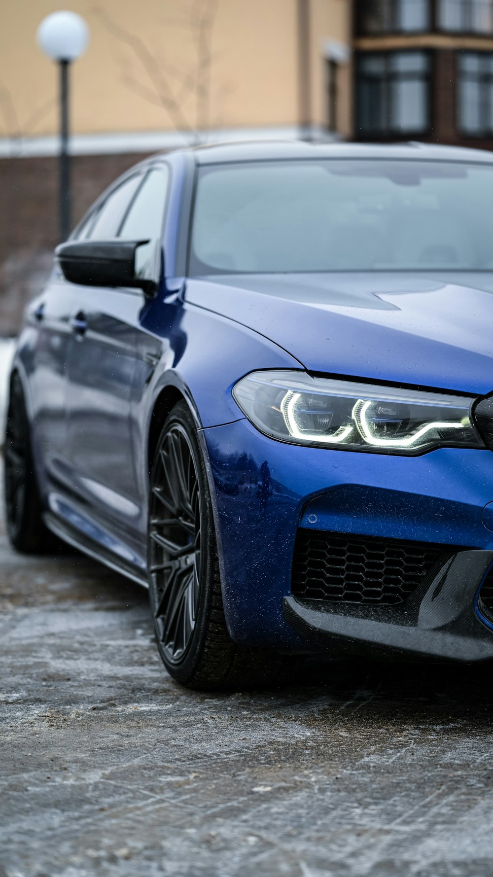 a blue car parked in front of a building