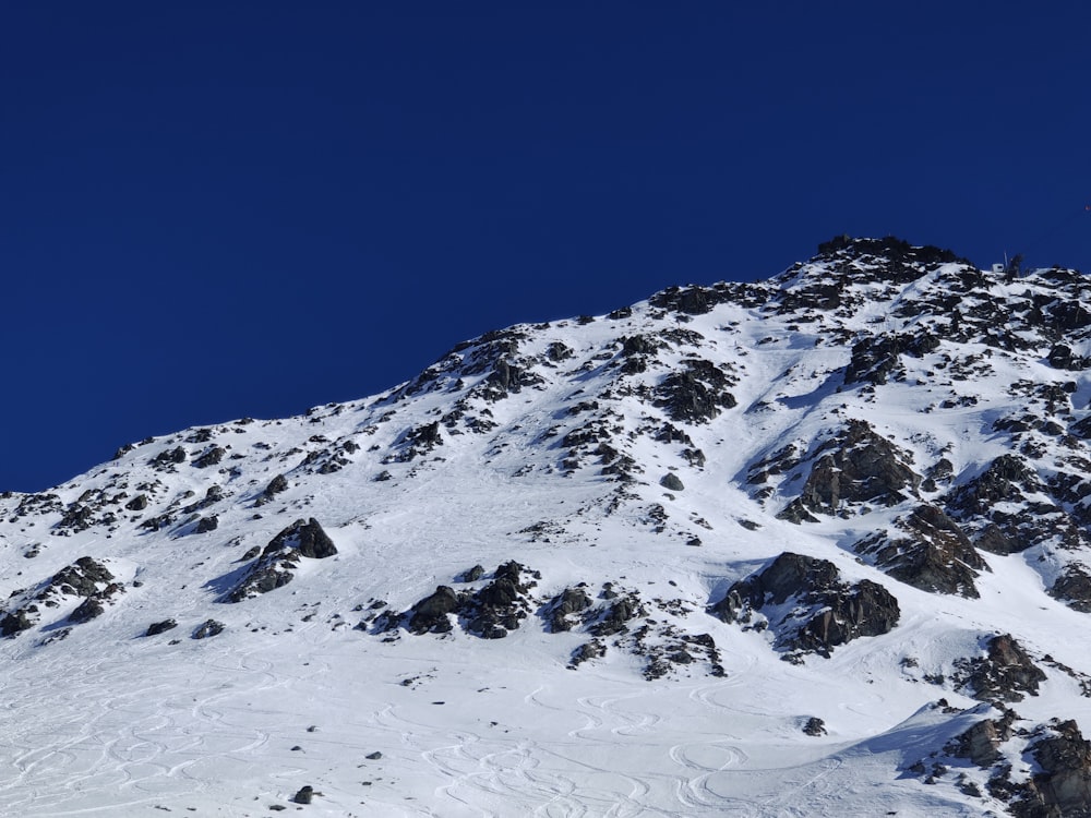 a snow covered mountain with a skier on it