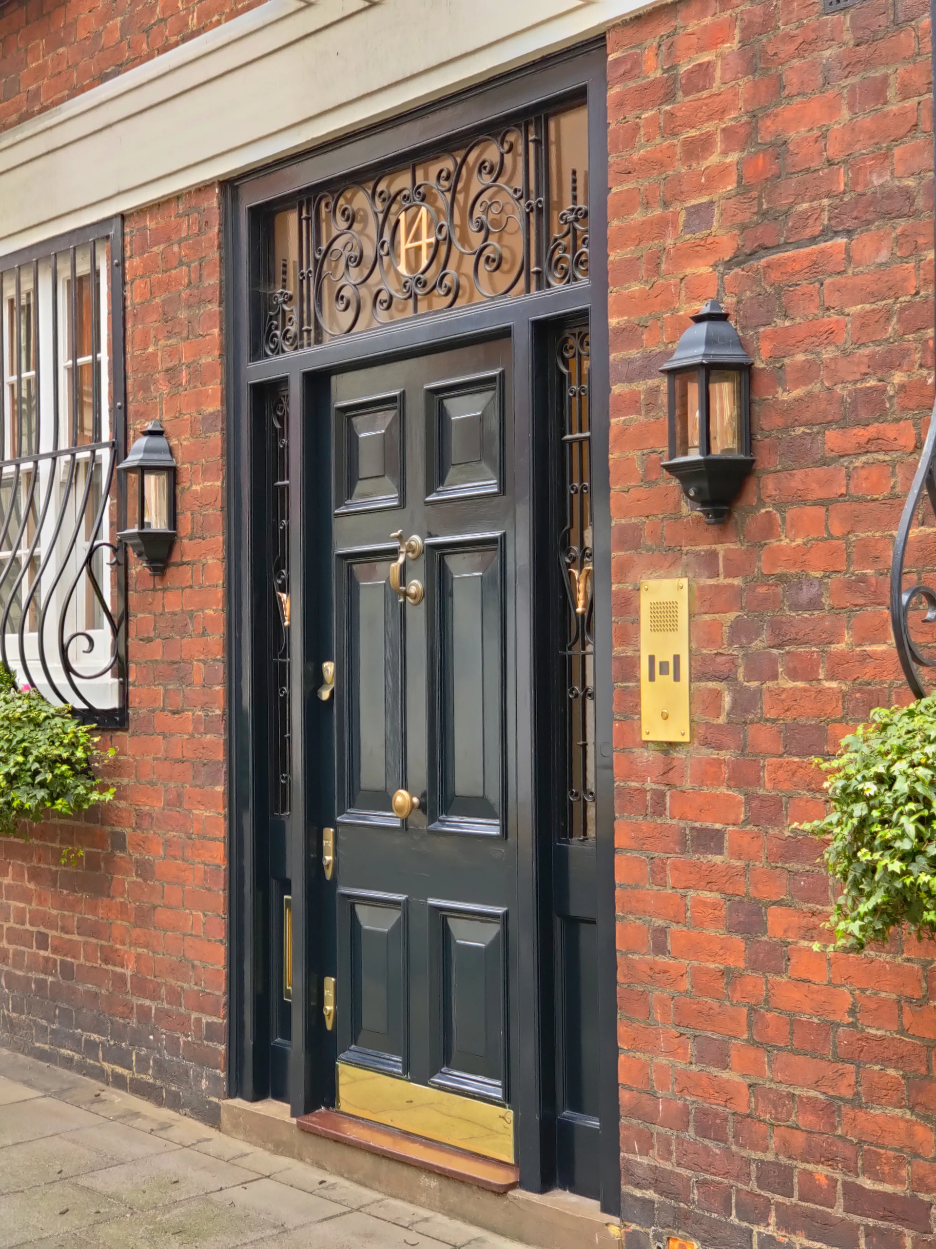 a brick building with a black front door
