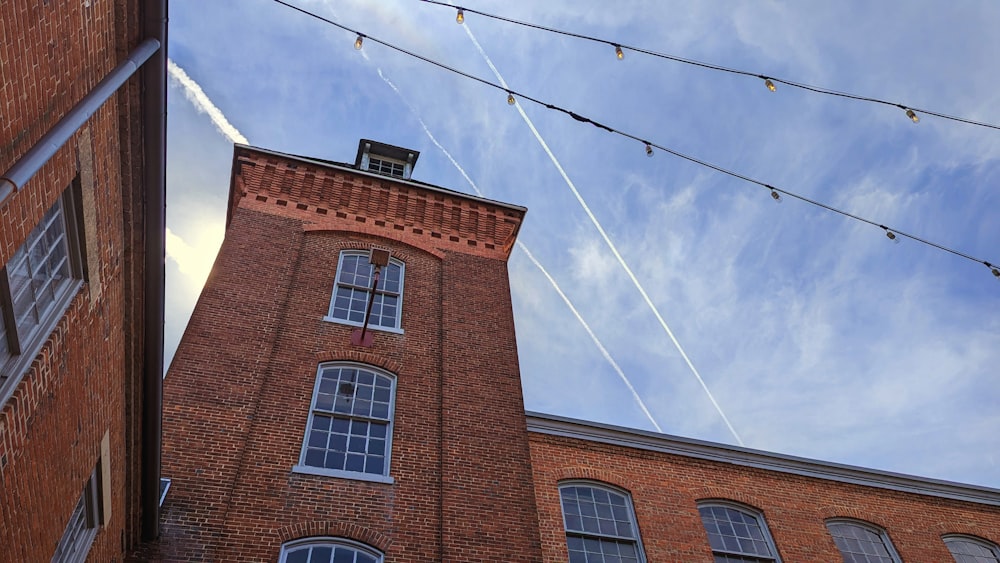 a tall brick building with a sky background