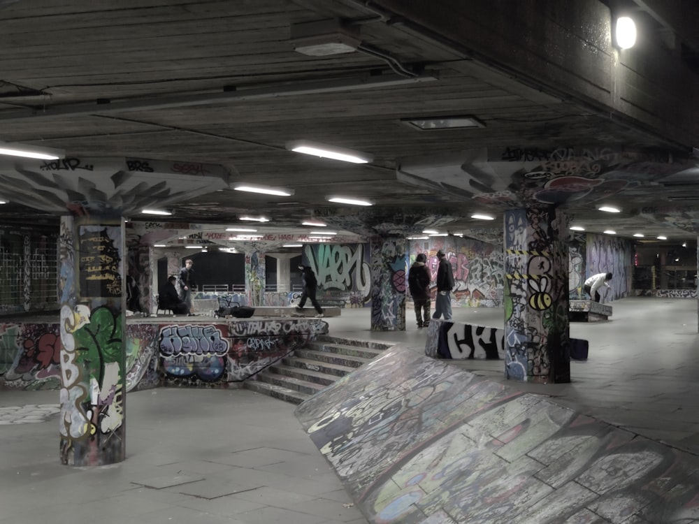 a group of people walking around a skate park