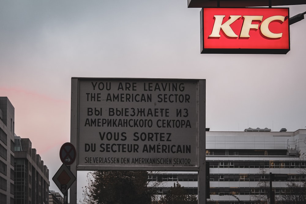 a kfc sign hanging off the side of a building