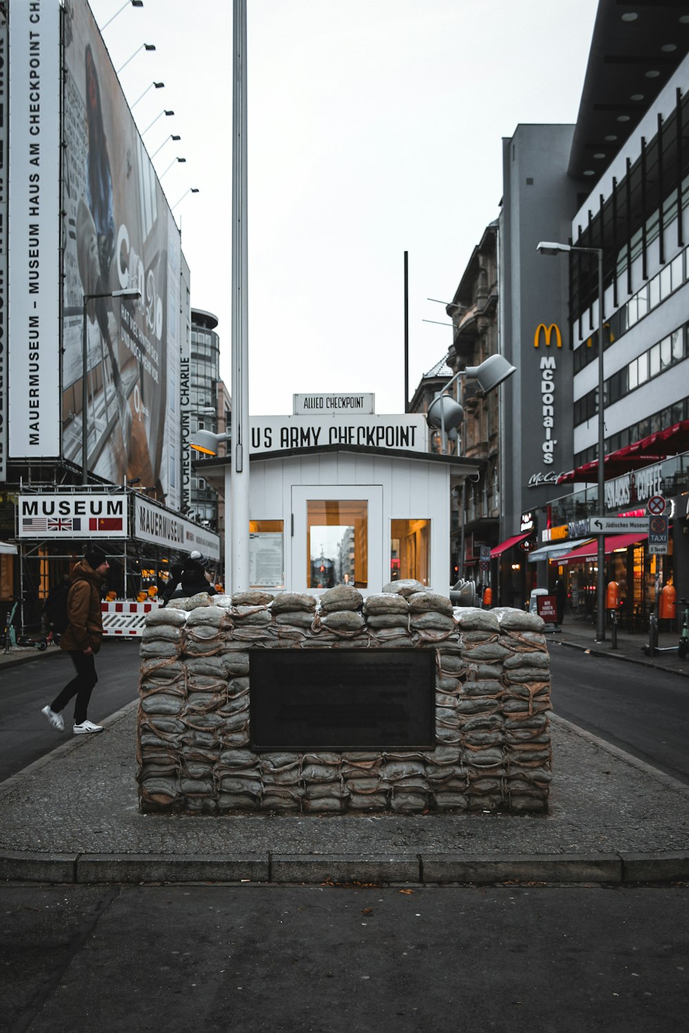 a building made out of rocks on a city street