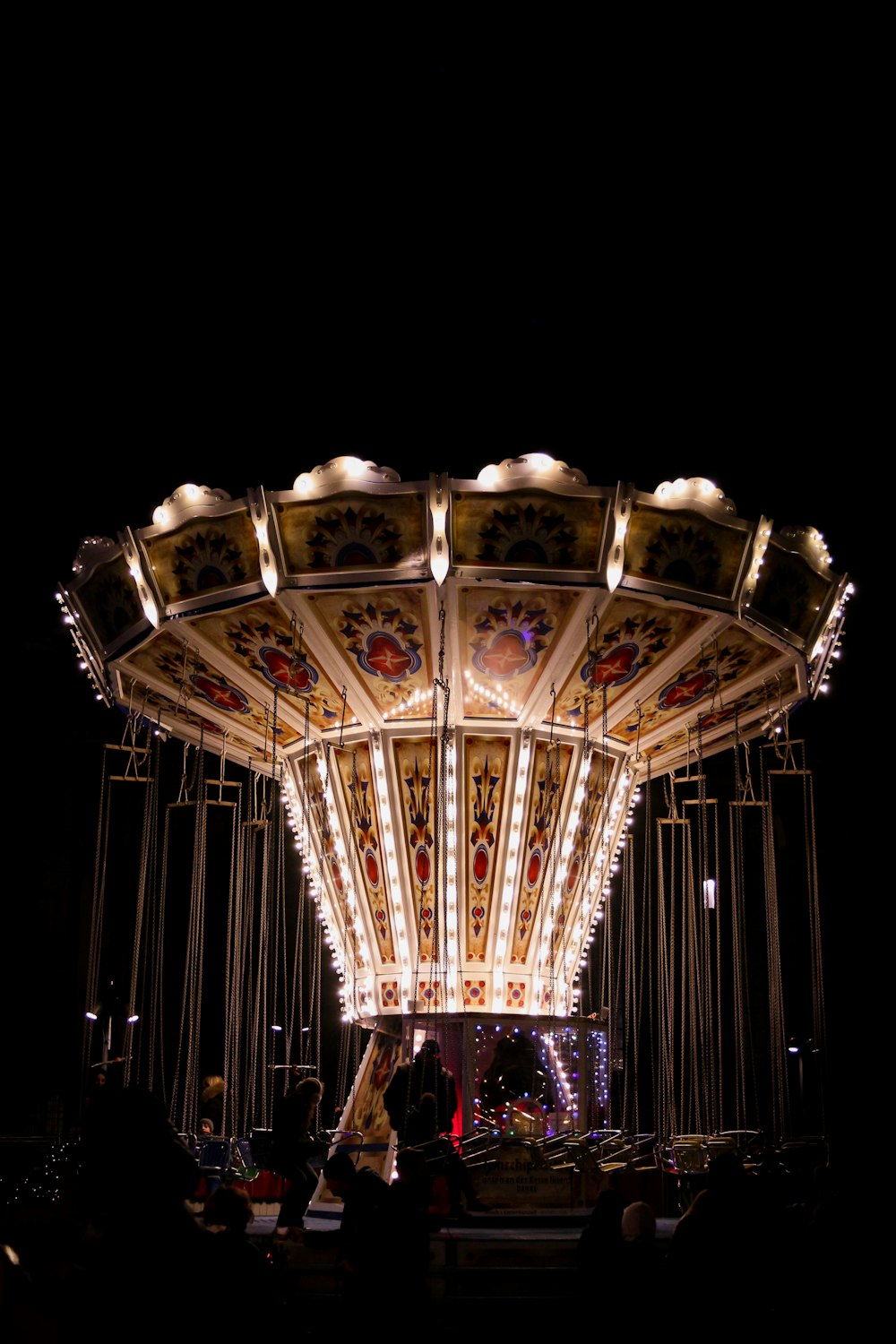 a merry go round at night with lights on