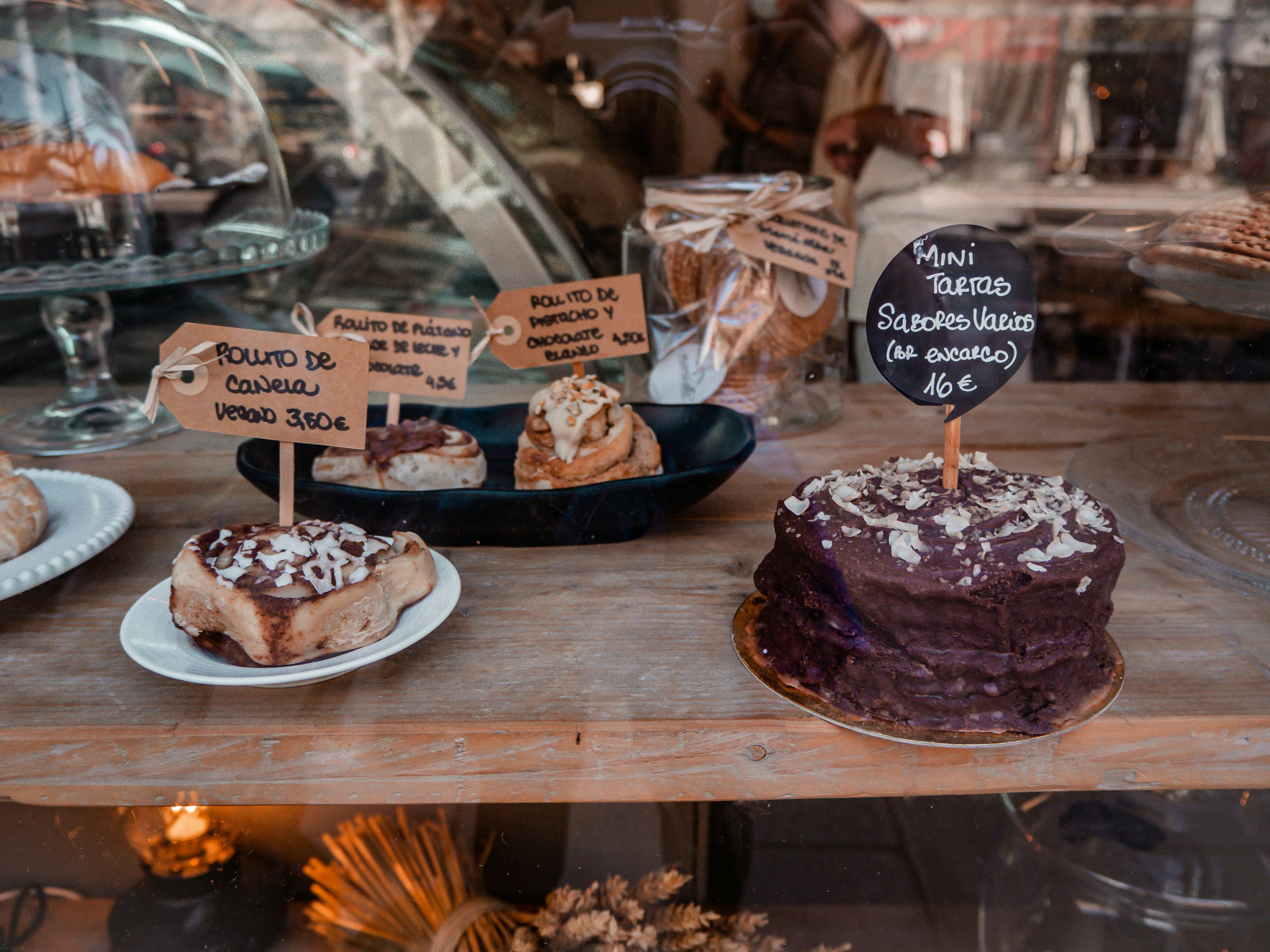 Cakes on a wooden shelf in a cafe.