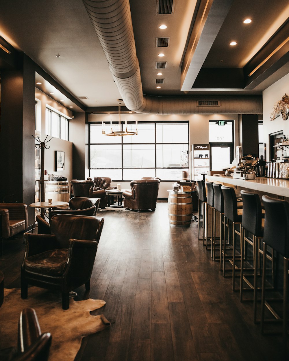 a large room with a bar and chairs