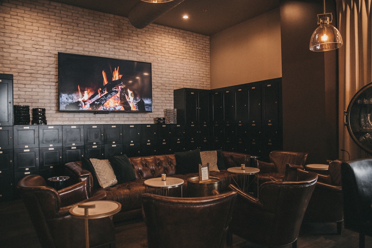 Members' room — leather wingback chairs and locker wall