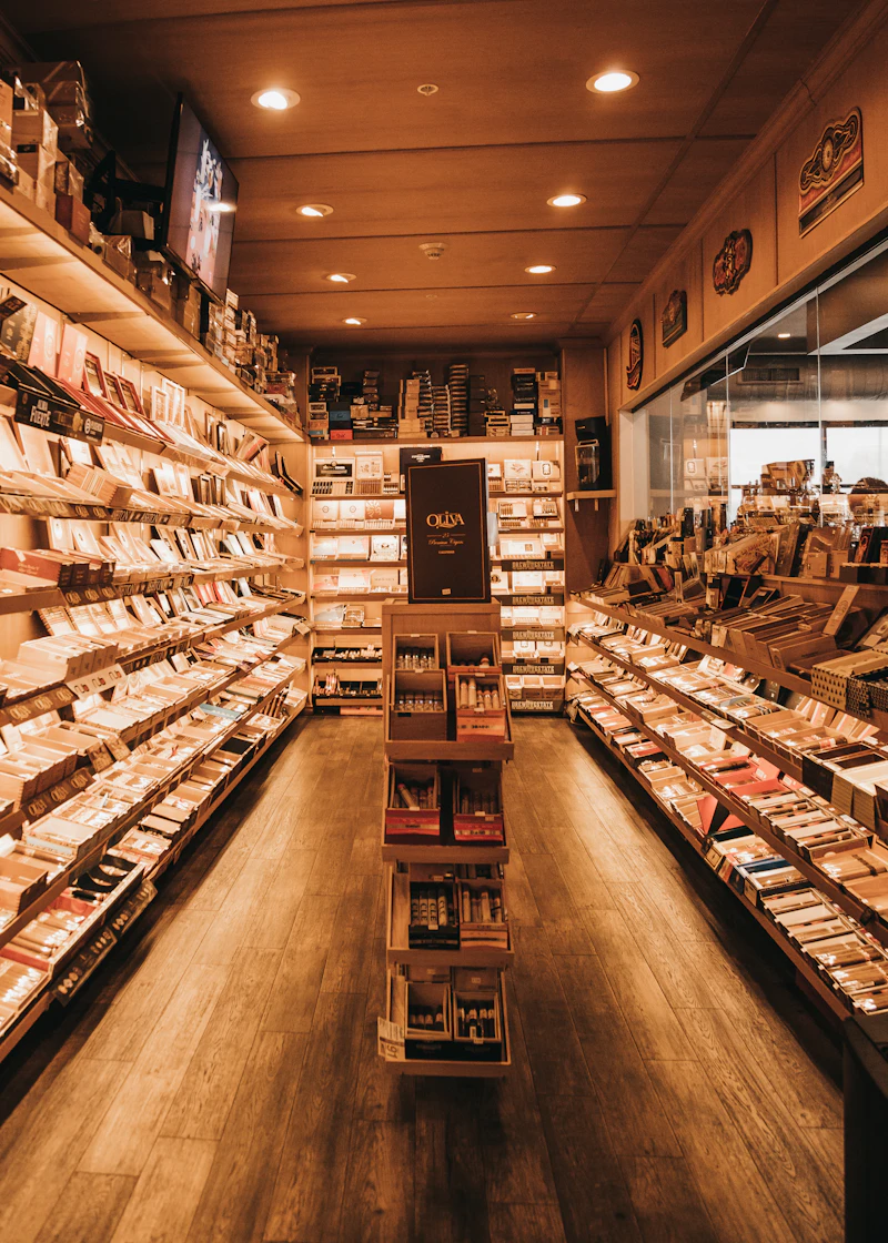 Aisle of cedar shelves stocked with cigar boxes in the walk-in humidor
