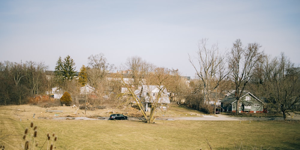 a car parked in a field next to a house