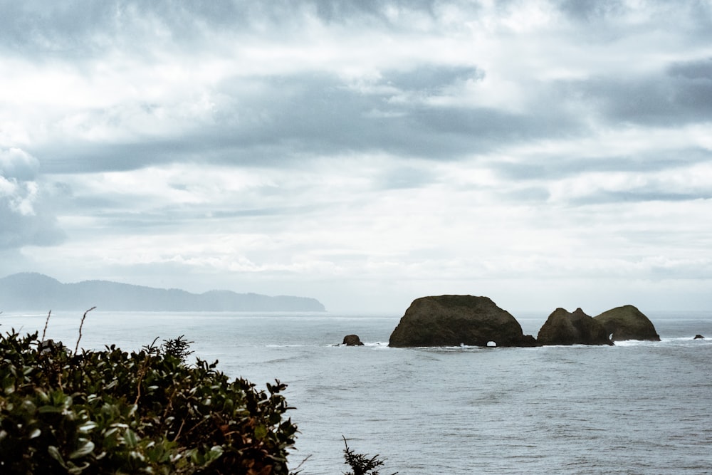 a couple of large rocks sitting in the middle of a body of water