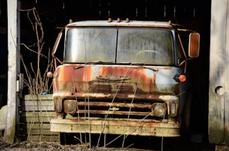 An infected creature lurking in the shadows near abandoned vehicles.