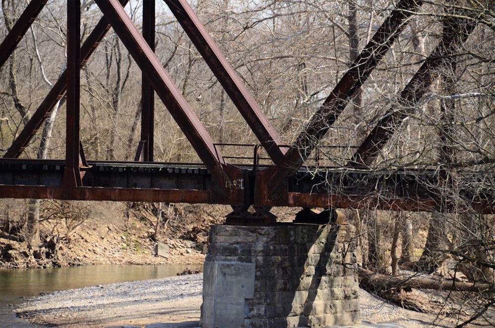 a bridge over a river in a wooded area