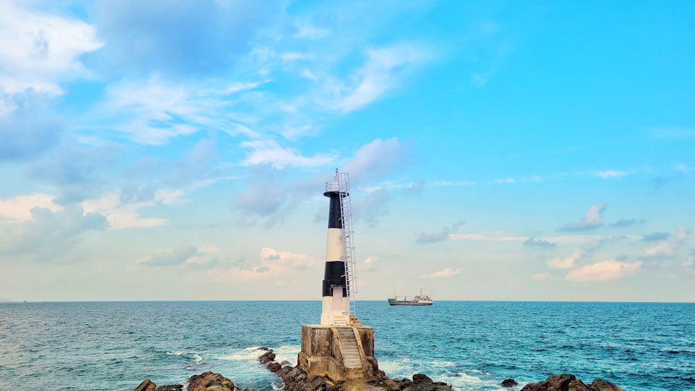 a light house sitting on top of a rock near the ocean