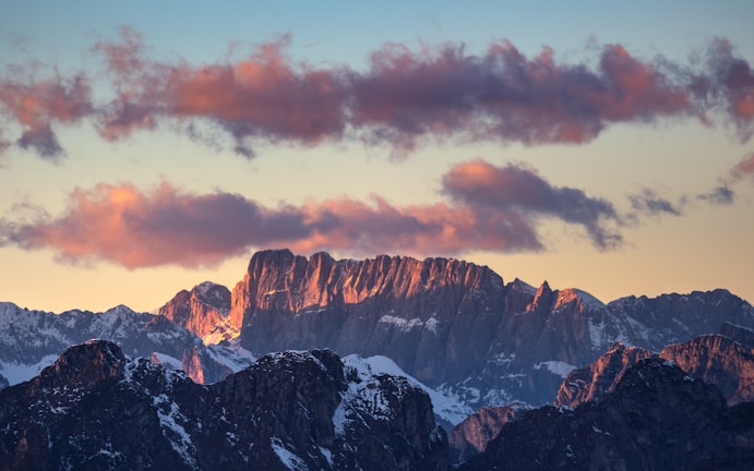 A majestic mountain range under a dramatic sunset.