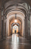 A grand entrance gate with floral arches and subtle lighting welcoming guests.