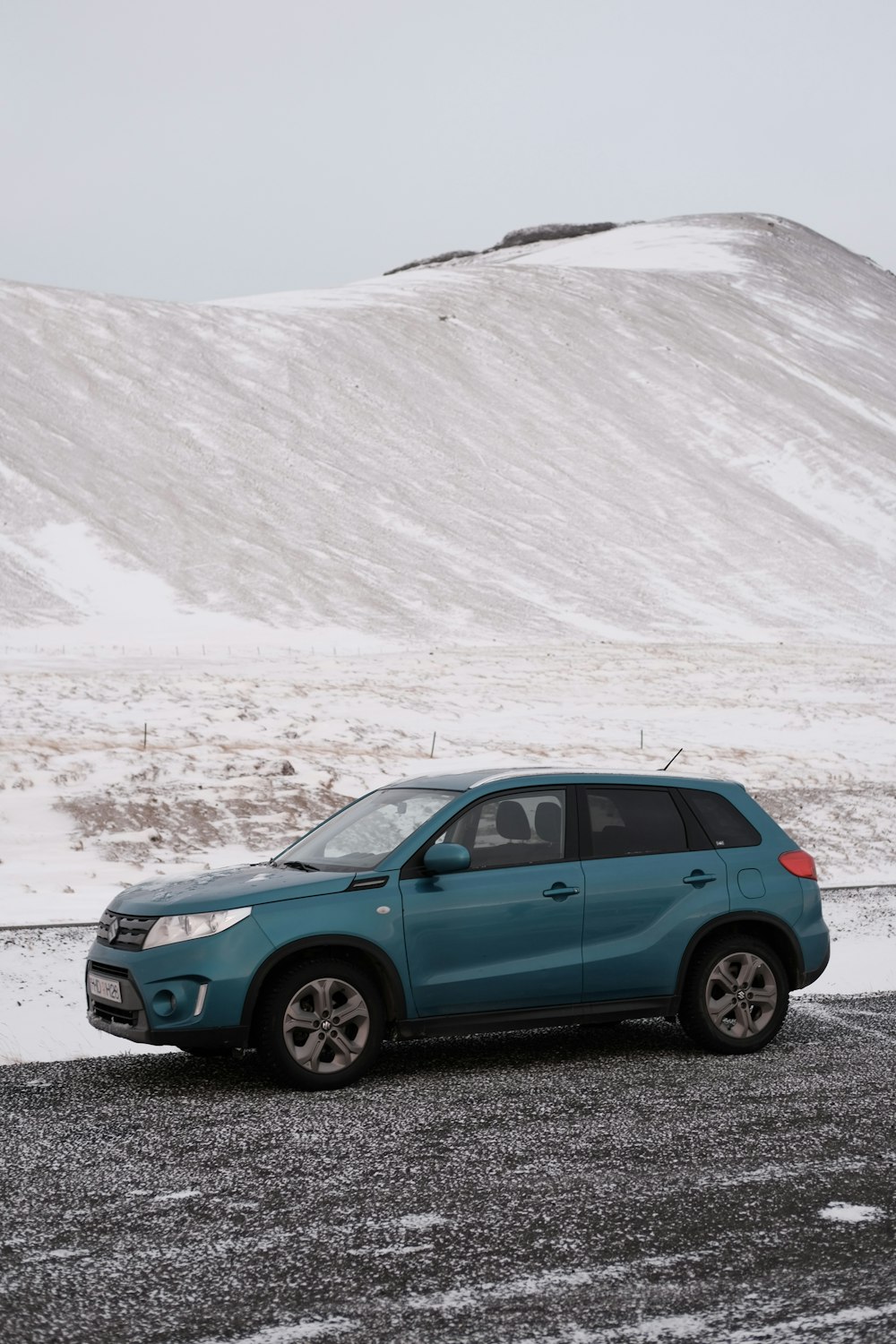 a blue car parked on the side of the road