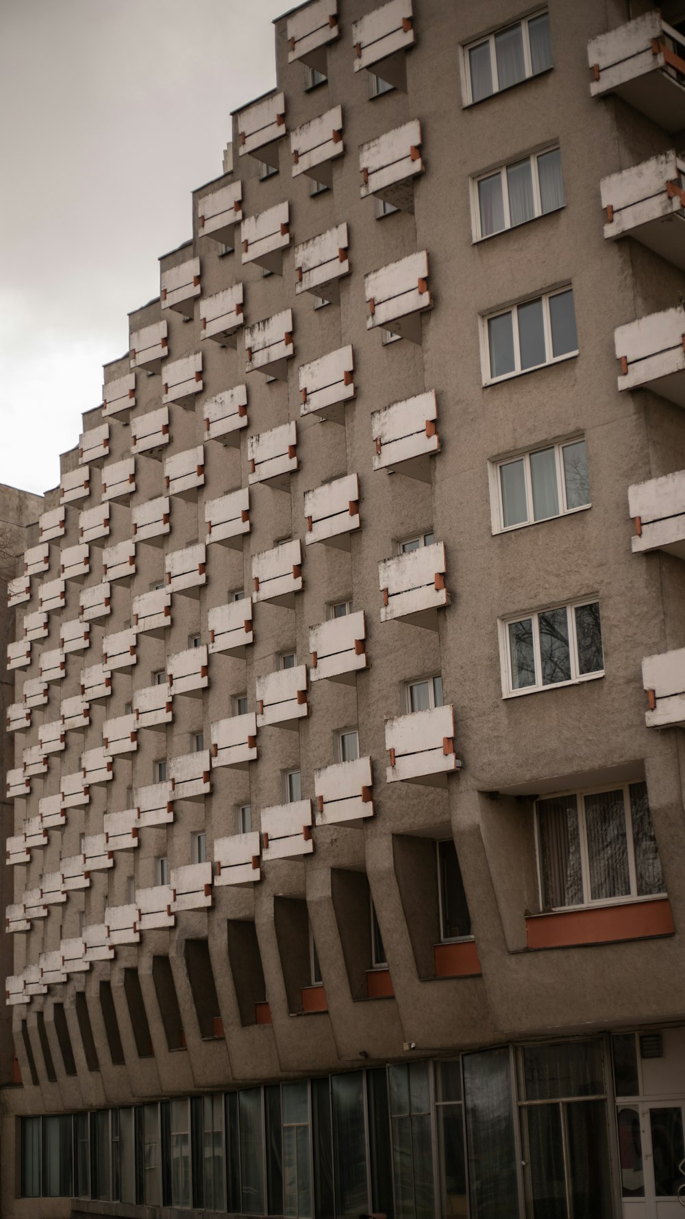 a tall building with lots of windows and balconies