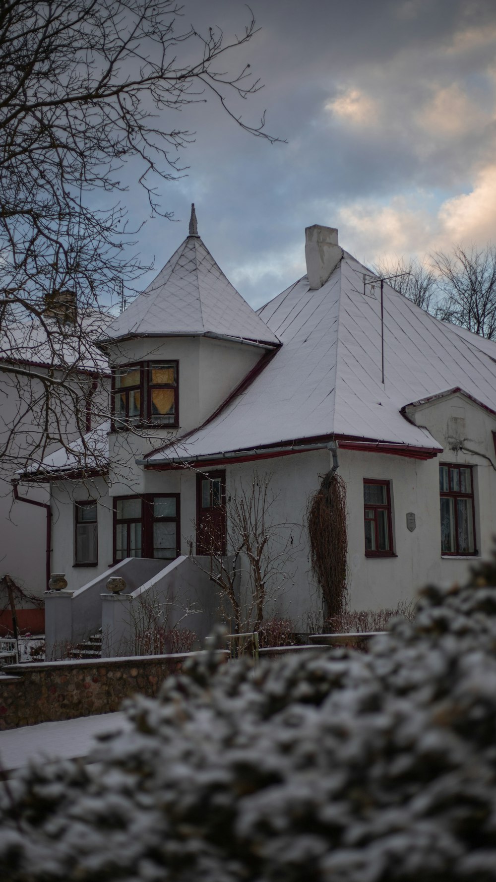 a house with a white roof covered in snow