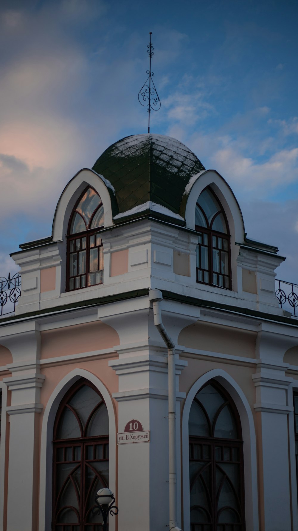 a building with a green roof and a clock tower