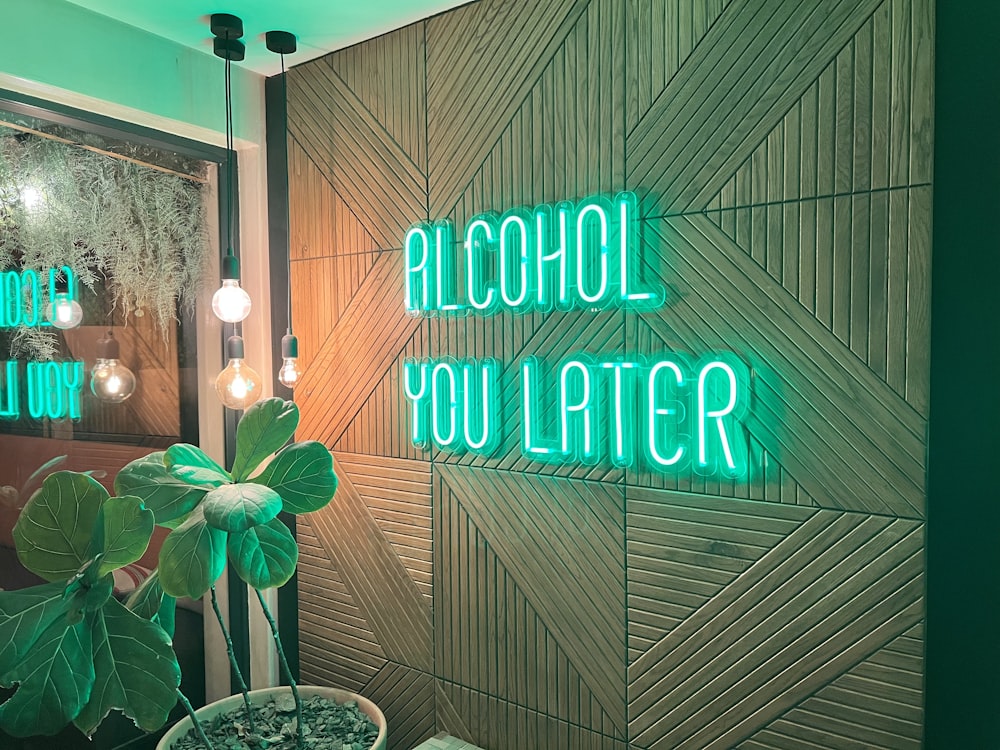 a green neon sign that reads alcohol you later
