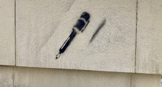 Close-up of a microphone with graffiti background.