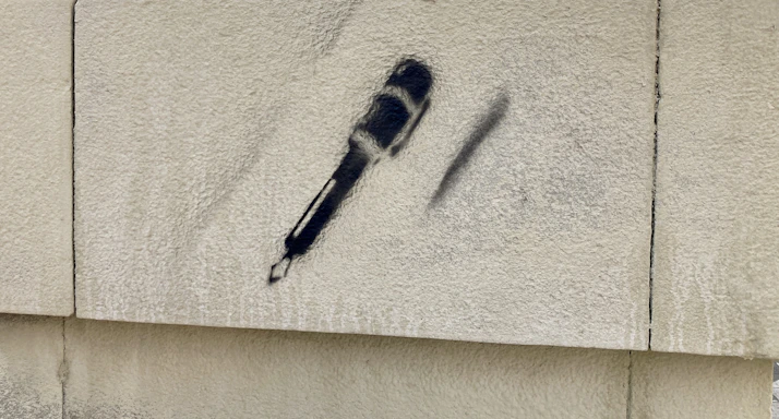 A vibrant mural of a microphone surrounded by graffiti art symbolizing the spirit of hip-hop culture.