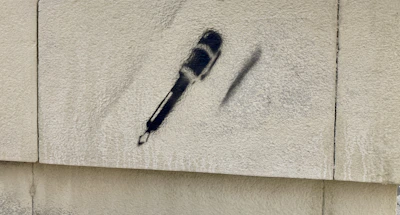 Close-up of a microphone with graffiti art in the background symbolizing urban culture.
