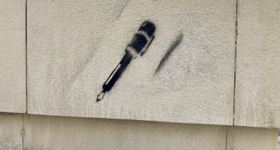 Close-up of a microphone with graffiti-style background in dark tones with bright accents