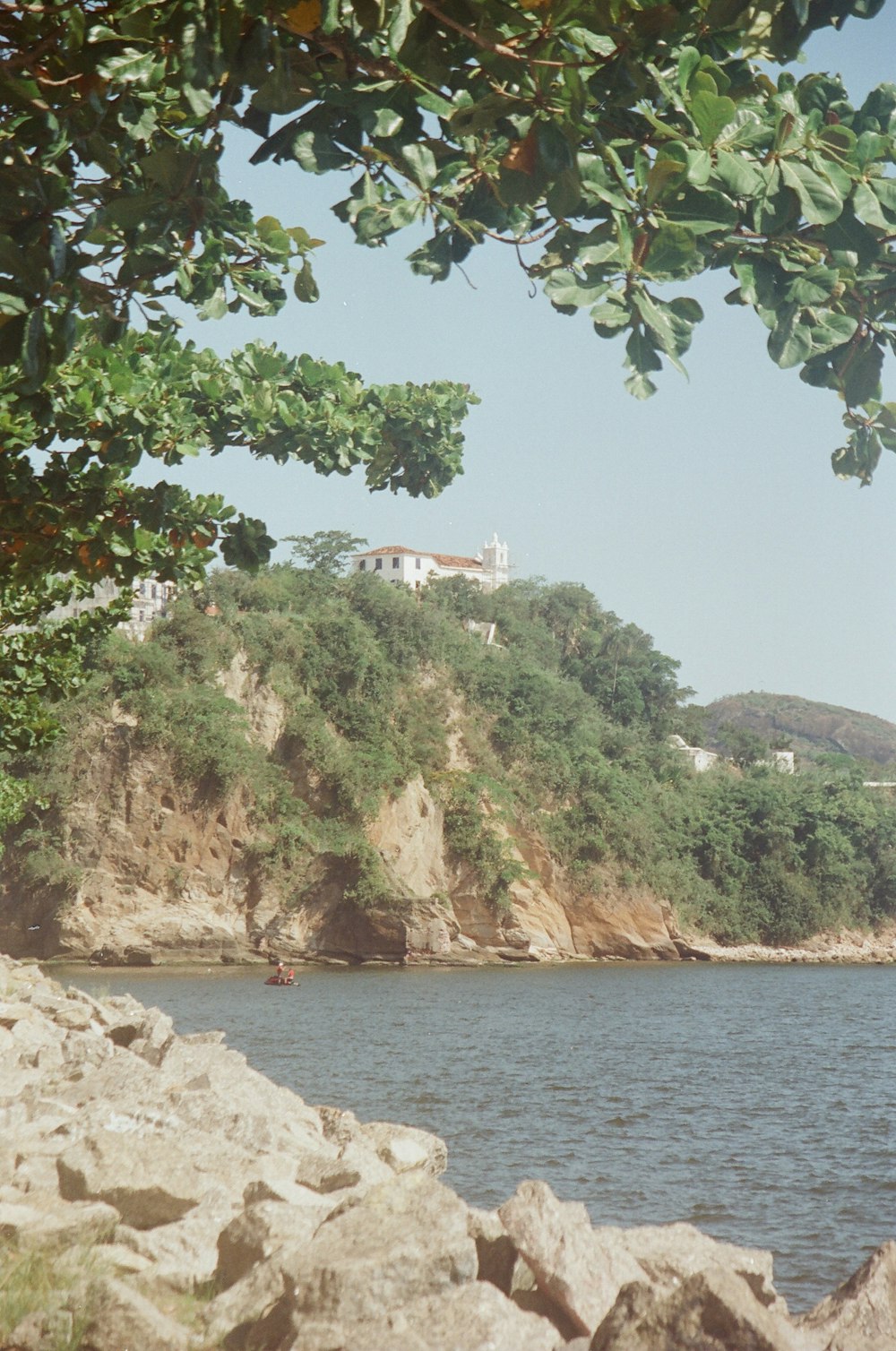 a body of water surrounded by rocks and trees