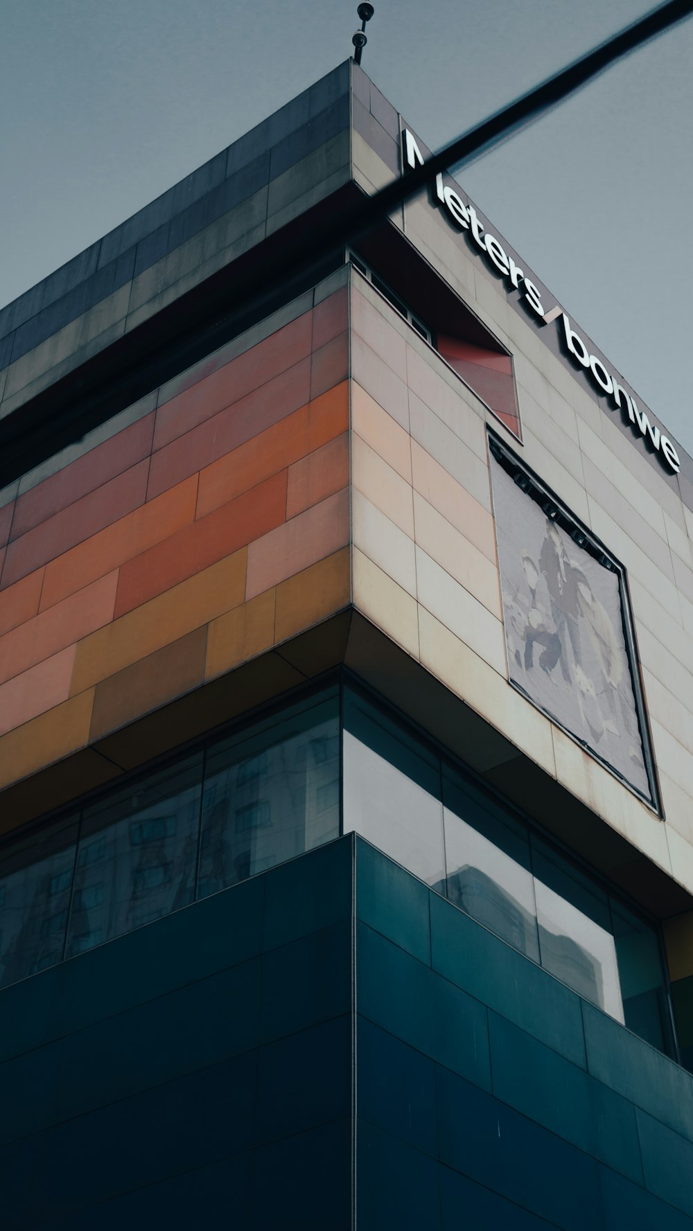 a tall building with a sign on the top of it