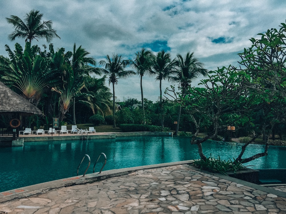 a pool with a stone walkway next to it