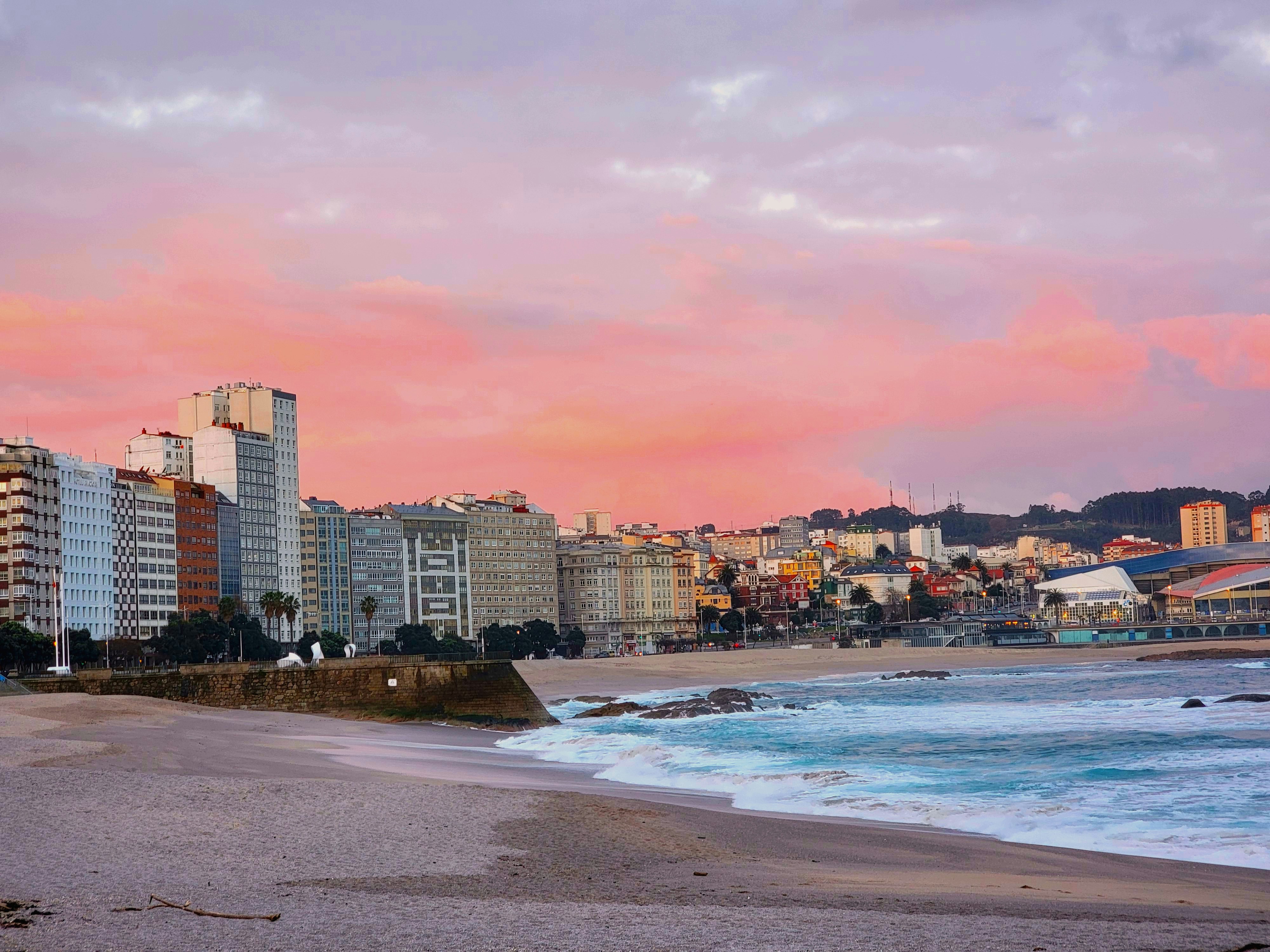 a view of a beach with buildings in the background