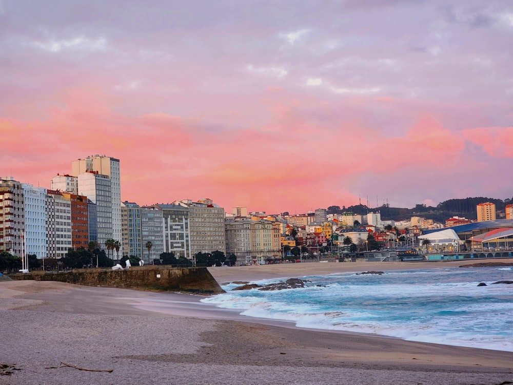 a view of a beach with buildings in the background