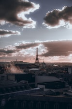 A moody shot of Paris skyline at dusk with music waves overlay.