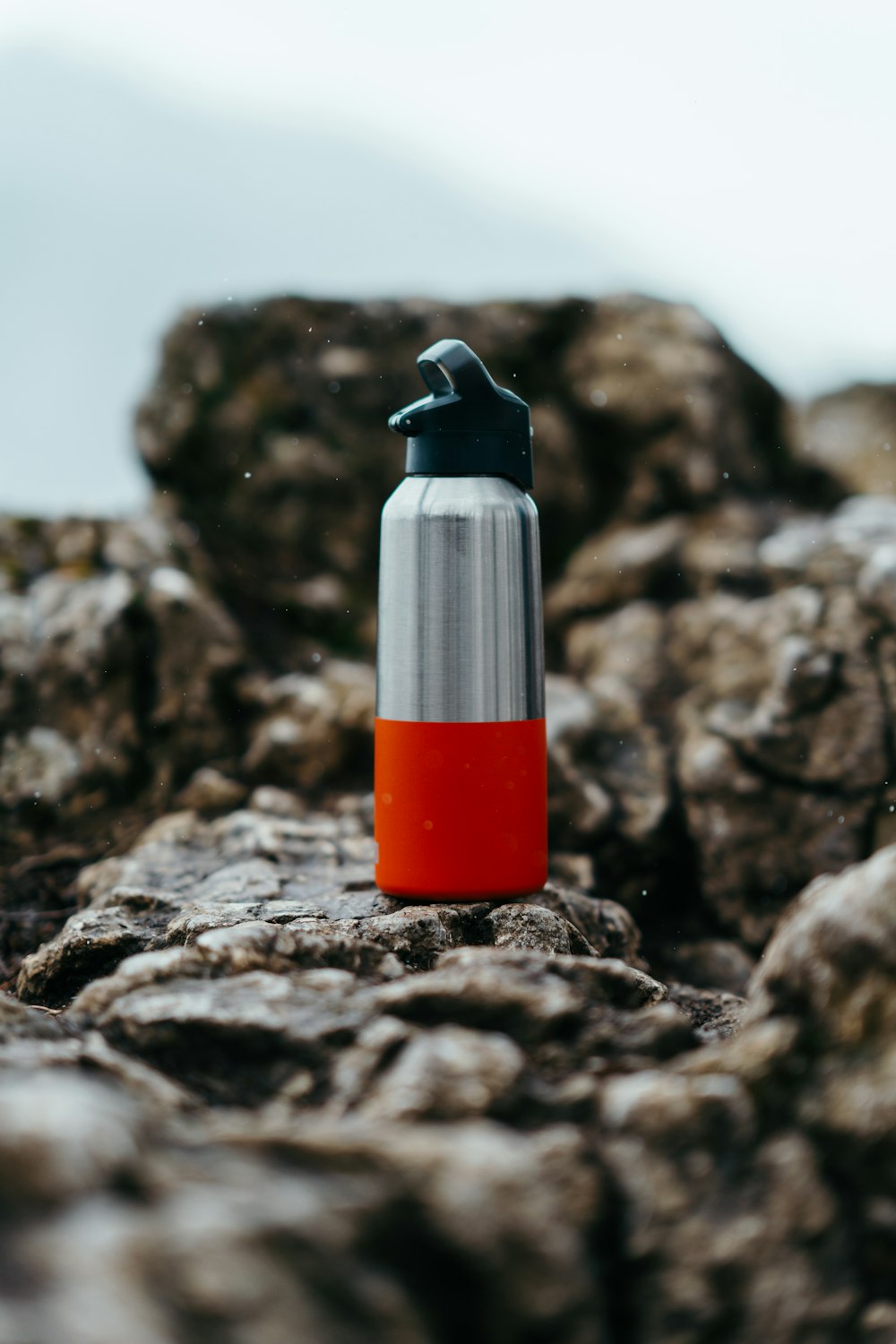 a water bottle sitting on top of a rock