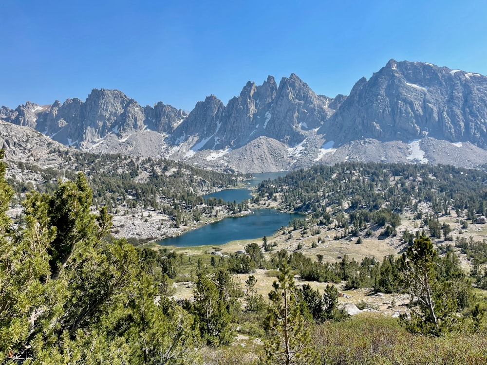 a view of a mountain range with a lake in the foreground